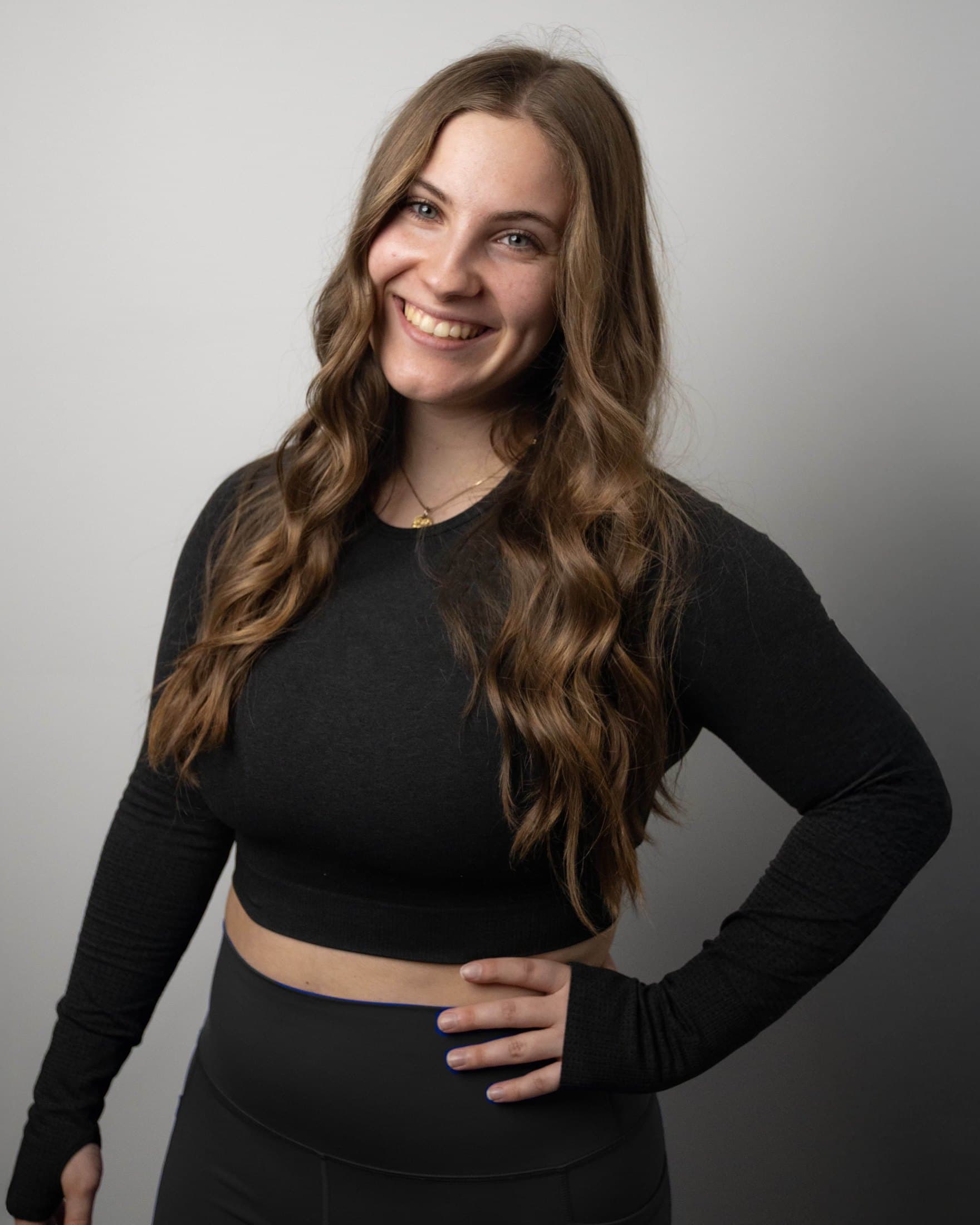 Jea, smiling in training clothes against a studio backdrop